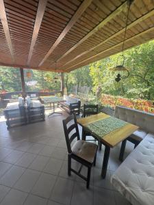 a patio with a table and chairs and a couch at Hotel boutique Garden Resort by Brancoveanu in Moieciu de Jos