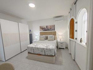 a bedroom with a bed in a white room at Casa Kevin in Puerto de Mogán