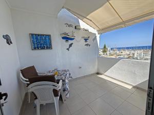 a room with a table and chairs and a window at Casa Kevin in Puerto de Mogán