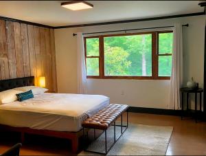 a bedroom with a large bed and a window at Lumen Catskill NY in Roscoe