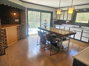 a kitchen with a table and chairs in a room at Lumen Catskill NY in Roscoe