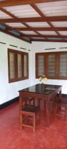 a table and two chairs in a room at Rainforest Soul Villa in Mederipitiya +29 photos