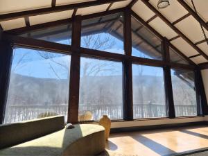 a room with a large window with a view of a mountain at Lumen Catskill NY in Roscoe