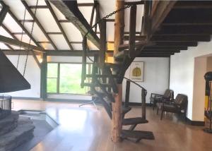 a living room with a spiral staircase in a building at Lumen Catskill NY in Roscoe
