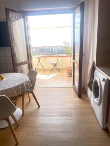 a living room with a door open to a balcony at Marina Panoramic Sea View in Scalea