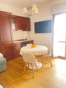a kitchen with a table and chairs in a room at Marina Panoramic Sea View in Scalea