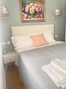 a bedroom with a bed with a painting on the wall at Marina Panoramic Sea View in Scalea