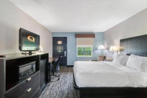 a hotel room with a bed and a flat screen tv at Quality Inn Adairsville-Calhoun South in Adairsville +22 photos