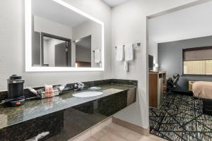 a bathroom with a sink and a large mirror at Quality Inn Cedartown in Cedartown +34 photos
