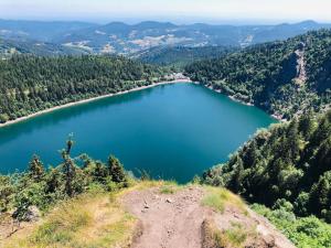 an aerial view of a lake in the mountains at Lodge de la WEISS in Lapoutroie