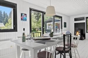 a kitchen and dining room with a white table and chairs at 8804-Glesborg-Vesttoften-20 in Glesborg