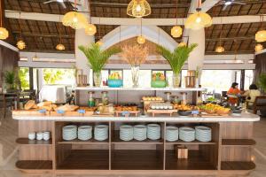 a buffet line with plates and food in a restaurant at Blue Haven Resort Quy Nhơn in Quy Nhon