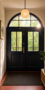 a black door with a window in a room at HAUS 1926 Łagów Boutique Villa in Łagów +138 photos