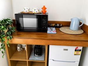 a microwave oven sitting on top of a counter at Chelsea Motor Inn in Coffs Harbour +75 photos