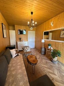 a living room with a couch and a table at Arena White Houses in Okuninka