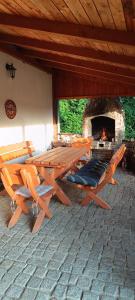 a picnic table and chairs in front of a fireplace at Chalupa Krbálka in Jeseník