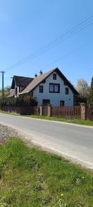 a white house on the side of a road at Chalupa Krbálka in Jeseník