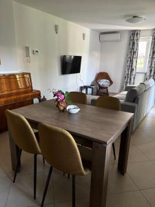 a living room with a wooden table and chairs at Crni mačak in Matulji