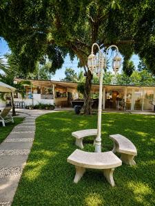 a park with two benches and a light pole at Villa Giacomelli Samui in Taling Ngam Beach
