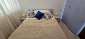 a bed with pillows on it in a bedroom at Casa Ida in Marotta