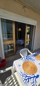 a room with a table and a chair and a balcony at Casa Ida in Marotta +3 photos