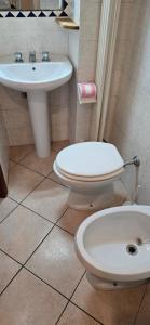 a bathroom with a toilet and a sink at Casa Ida in Marotta