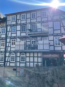 a large building with a balcony in front of it at Fluss-Bett in Melsungen +3 photos