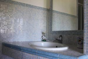 a bathroom with a sink and a mirror at Appartamento Stella Marina in Marcelli