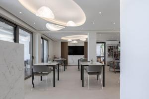 a dining room with tables and chairs at Bella Vista Hotel "by Checkin" in Hersonissos