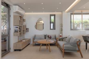 a living room with two chairs and a table at Bella Vista Hotel "by Checkin" in Hersonissos
