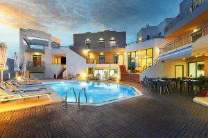 a large house with a swimming pool in the yard at Bella Vista Hotel "by Checkin" in Hersonissos