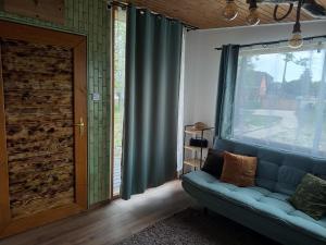 a living room with a couch and a large window at Sóz-Lak in Mezőcsát