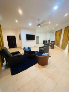 a living room with couches and a flat screen tv at Teiman Apartments in Teiman