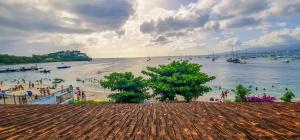 a view of a beach with boats in the water at Villa bougainvillier in Les Trois-Îlets