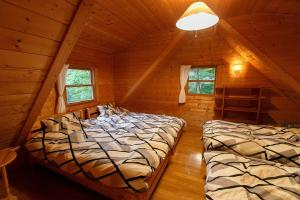 a bedroom with two beds in a log cabin at ログハウス那須ハイグランド in Nasu +101 photos