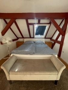 a bed in a room with a window at Über der Brücke in Melsungen