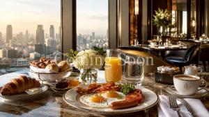 a breakfast table with eggs and croissants in a restaurant at Loei Buri Hotel by Alphatel in Ban Tha Phae