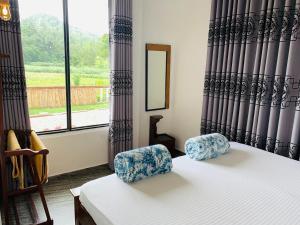a bedroom with a bed and two chairs and a window at HAPUTHALE Ceylon shadow in Haputale +92 photos