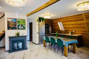 a kitchen with a dining table and a fireplace at A Frame Poalele Transalpinei in Novaci-Străini