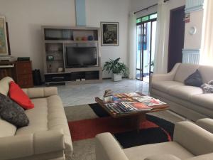 a living room with two couches and a coffee table at Hotel Tourist Araranguá in Araranguá