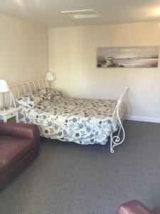 a bedroom with a bed and a couch at Fishermans Rest in Newport