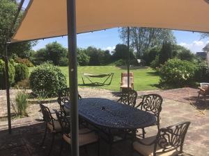 a table and chairs under an umbrella on a patio at Fishermans Rest in Newport