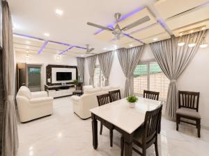 a living room with a table and chairs at Ansh Bunglow in Belgaum