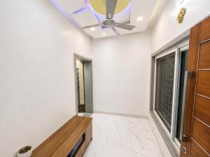 a room with a ceiling fan and a window at Ansh Bunglow in Belgaum +2 photos