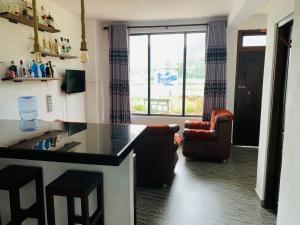 a kitchen with a counter and a chair and a window at HAPUTHALE Ceylon shadow in Haputale