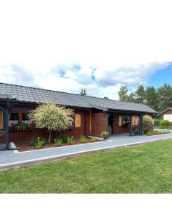 a house with a gambrel roof at Arena White Houses in Okuninka