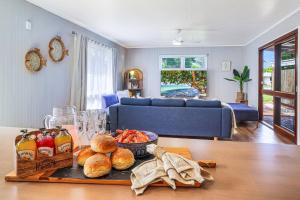 a living room with a tray of food on a table at The Hideaway in Bargara