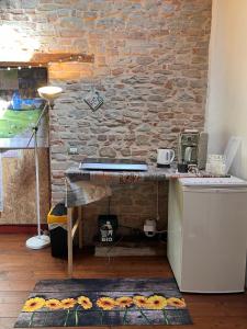 a kitchen with a desk and a brick wall at The Bookhouse Home Bb in Poggio San Marcello  +37 photos