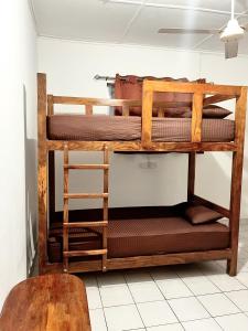 two bunk beds in a room with a table at Feel Like Home Hostel Anuradhapura in Anuradhapura +25 photos