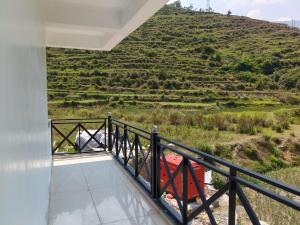 a balcony with a view of a hill at Hotel Shri Mahavir in Chamoli +16 photos
